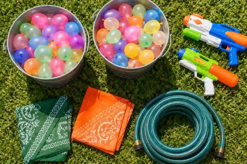 Water capture the flag gear: balloon buckets, hose, team bandanas, and backup blasters